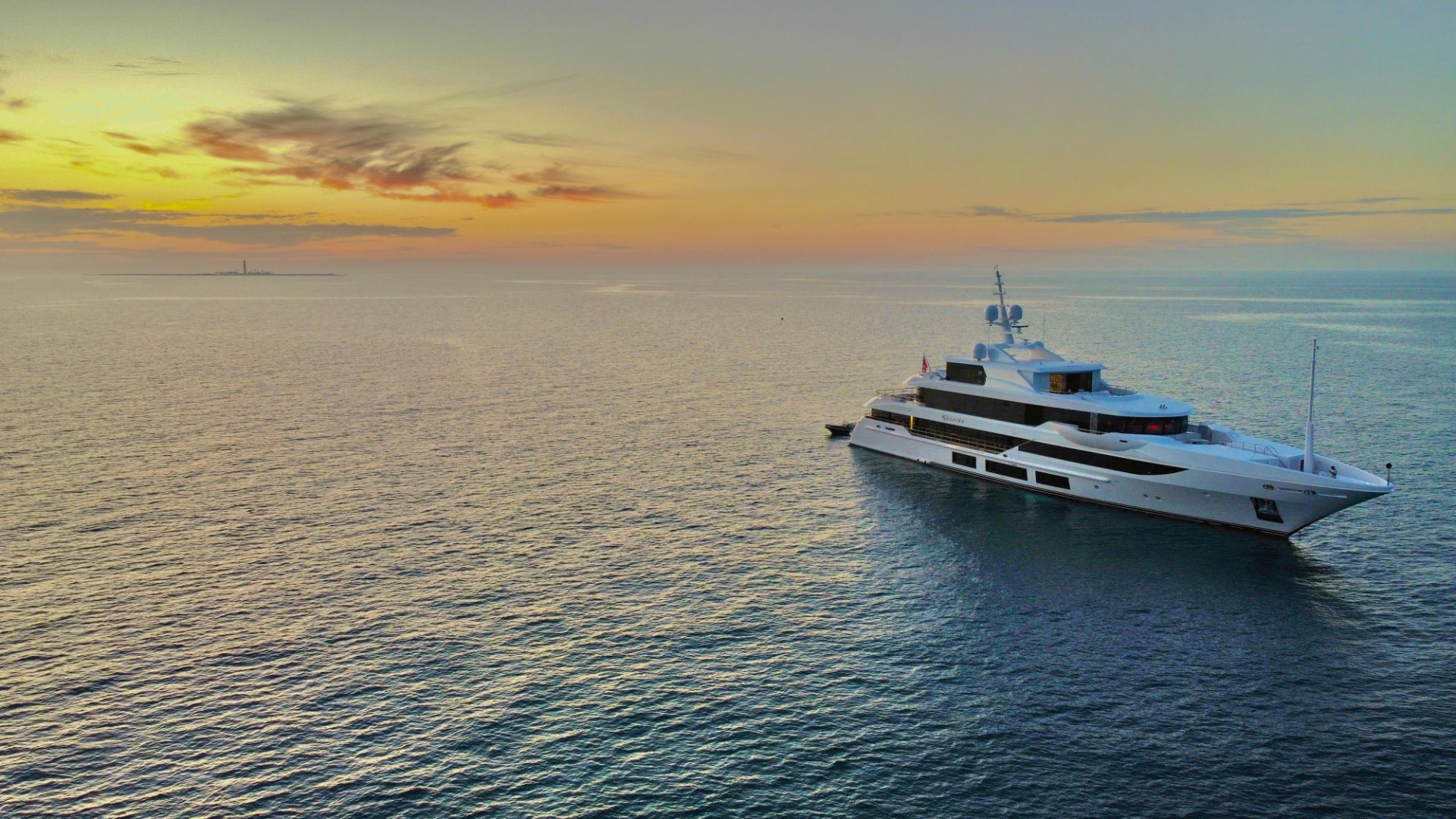 56-metre motor yacht Surpina at anchor at sunset
