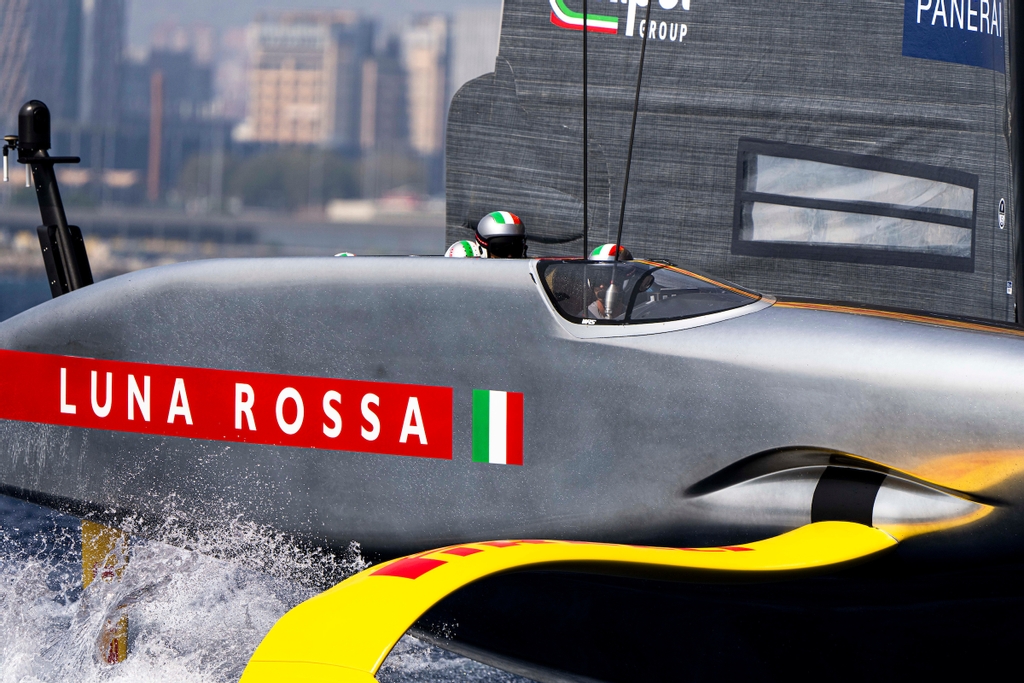 Detail of Luna Rossa’s silver AC75 hull and yellow foil racing in Barcelona in 2024
